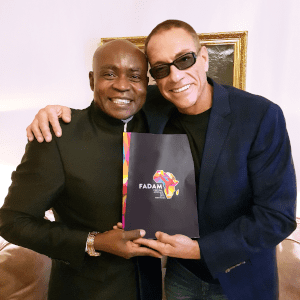 Jean-Claude Van Damme and Dominique Saatenang posing together for a photo