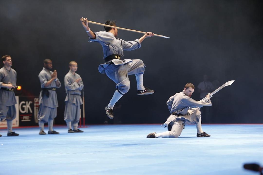An athlete jumping during a martial arts demonstration